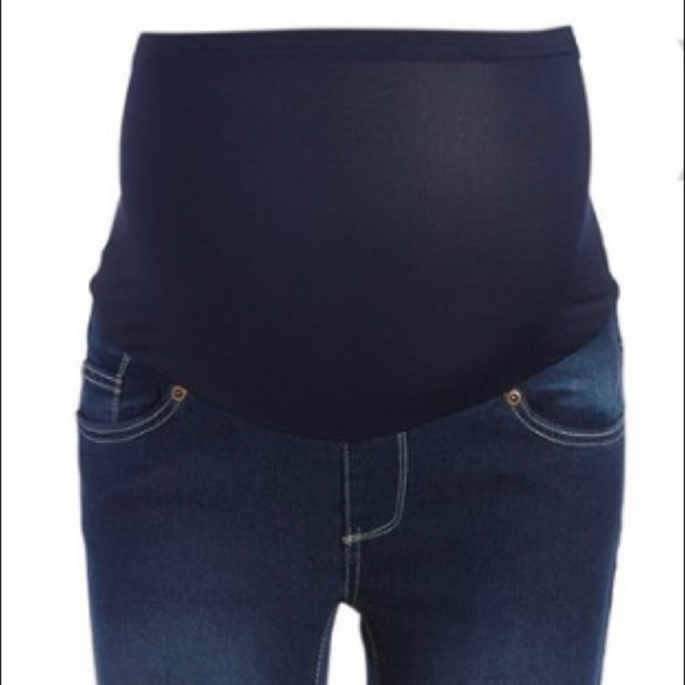 Dark distressed denim roll cuff over belly jeans